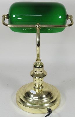 Lot 44 - A brass desk lamp, with an adjustable green...