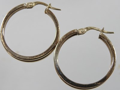 Lot 255 - A pair of 9 carat gold hoop earrings, of...