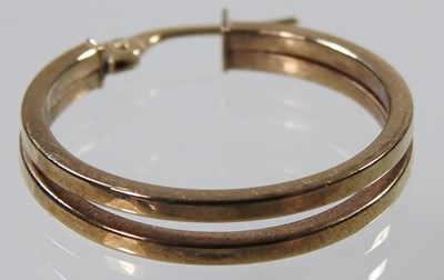 Lot 255 - A pair of 9 carat gold hoop earrings, of...