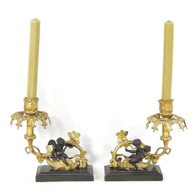 Lot 137 - A pair of gilt candlesticks, with bronzed...