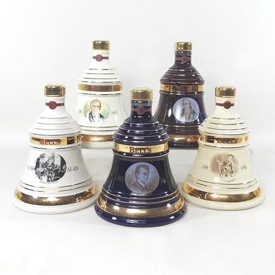 Lot 396 - A collection of five Bells whisky decanters,...