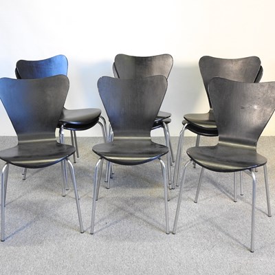 Lot 521 - A set of nine black stacking dining chairs, in...