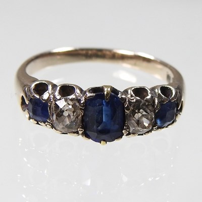 Lot 462 - A sapphire and diamond ring, set with a row of...