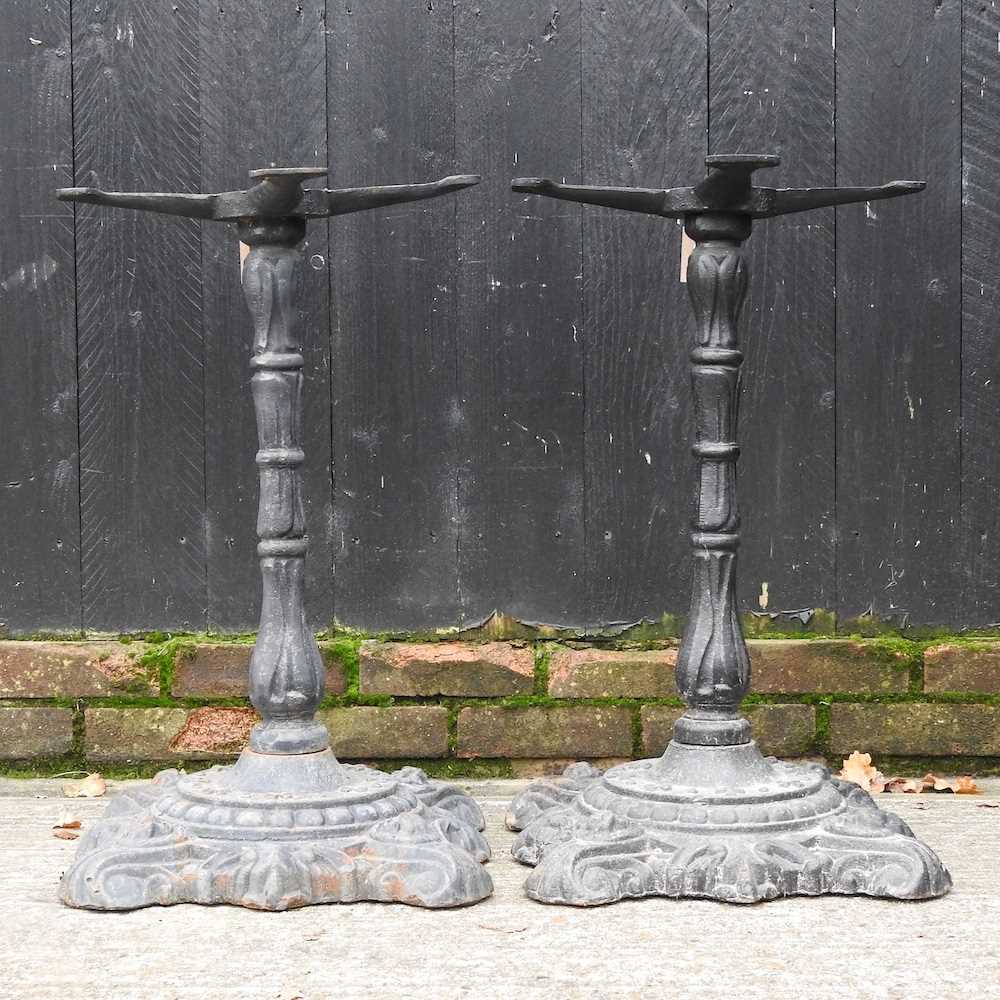 Lot 513 - A pair of cast iron table bases, 70cm high (2)