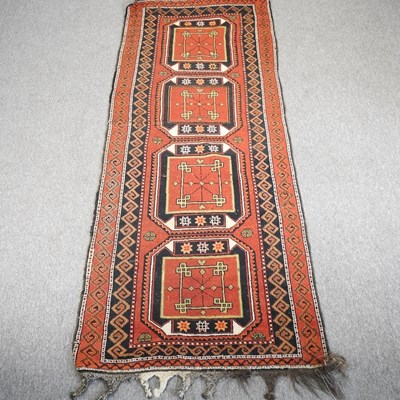 Lot 202 - A kazak woollen runner, with a row of four...