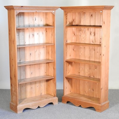 Lot 133 - A pair of pine standing open bookcases, each...