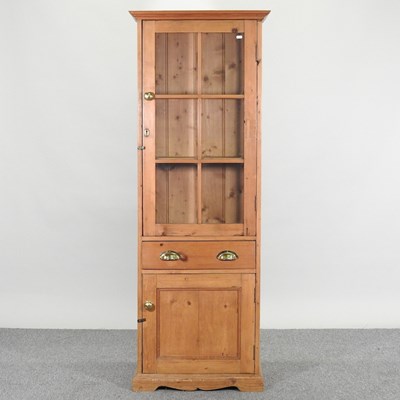 Lot 346 - An antique pine narrow cabinet, with a glazed...