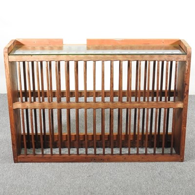Lot 32 - An antique pine hanging plate rack, with a...