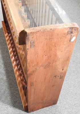 Lot 32 - An antique pine hanging plate rack, with a...