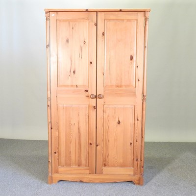 Lot 370 - A modern pine double wardrobe, with panelled...