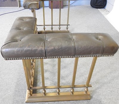 Lot 7 - A brass club fender, with a buttoned leather seat