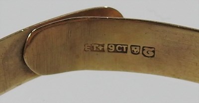 Lot 554 - A 9 carat gold bangle, with engraved...