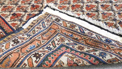 Lot 46 - A Persian carpet, with all over flowerhead...