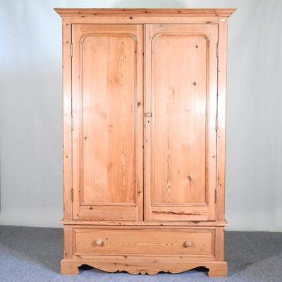 Lot 111 - A pine double wardrobe, with a moulded cornice...