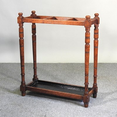 Lot 520 - An early 20th century oak stick stand, with a...