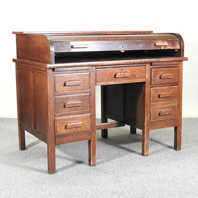 Lot 160 - A 1920's oak pedestal desk, with a tambour top,...