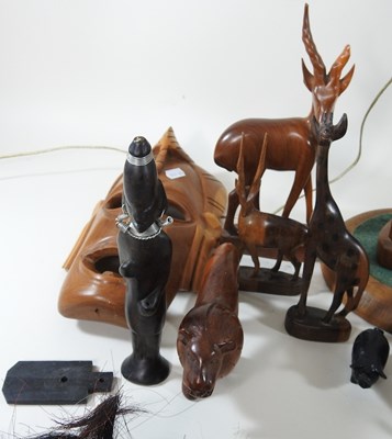 Lot 69 - A collection of African hardwood carvings and...