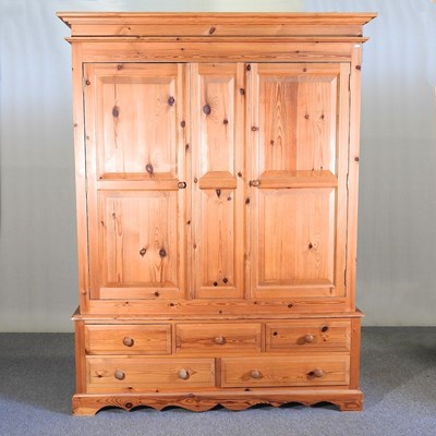 Lot 566 - A modern pine double wardrobe, with drawers below