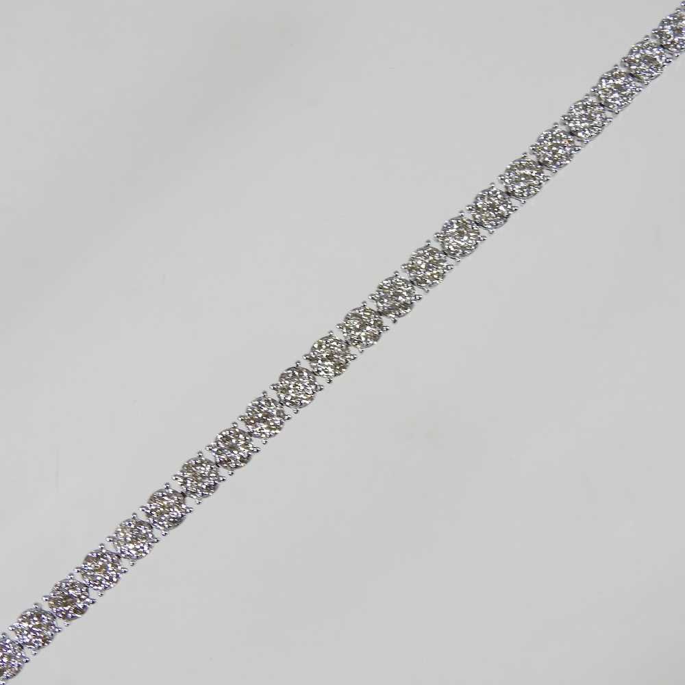 Lot 413 - A 9 carat white gold diamond set line