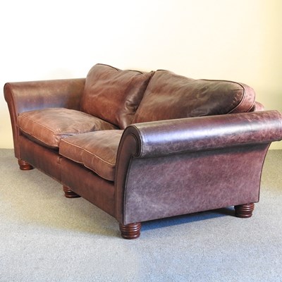 Lot 393 - A large brown leather upholstered sofa, on...