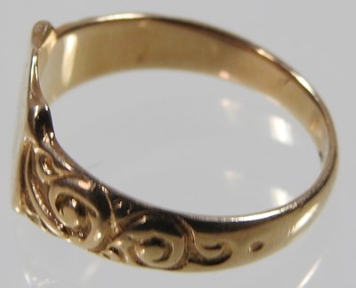 Lot 15 - A 9 carat gold signet ring, the central shield...