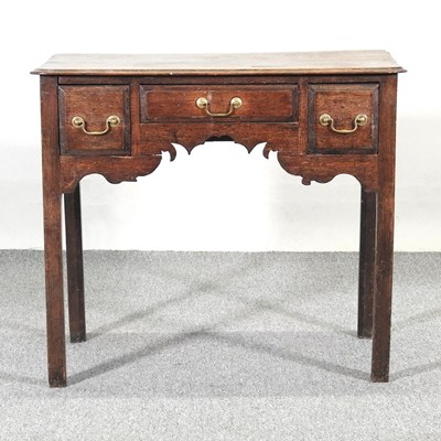 Lot 167 - An 18th century oak lowboy, containing three...