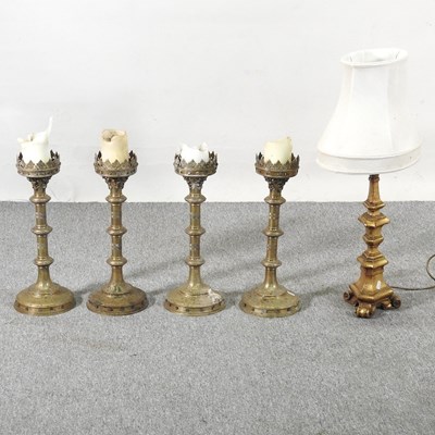 Lot 93 - A set of four ornate brass pricket...