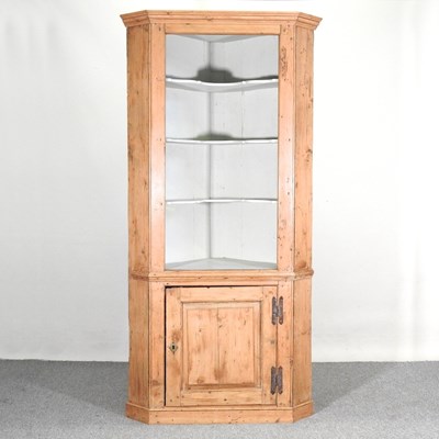 Lot 131 - An antique pine standing corner cabinet, with...