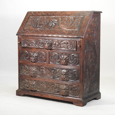 Lot 315 - A 19th century heavily carved dark oak bureau