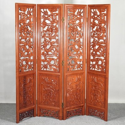 Lot 262 - An oriental carved wooden four-fold dressing...