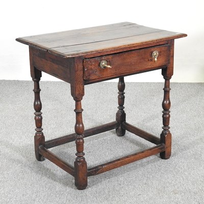 Lot 234 - An 18th century oak side table, containing a...