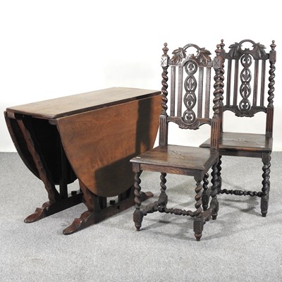 Lot 261 - An early 20th century oak drop leaf dining...