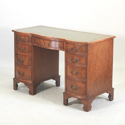Lot 317 - A mid 20th century walnut serpentine pedestal desk