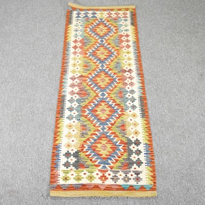 Lot 236 - A kilim runner, with a row of five central...