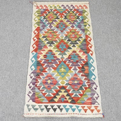 Lot 225 - A kilim runner, with all over coloured...