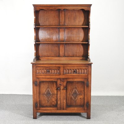 Lot 102 - A mid 20th century carved oak dresser, by...