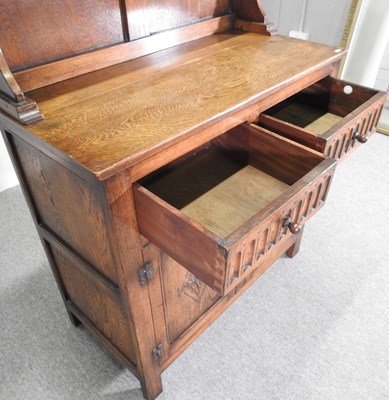 Lot 102 - A mid 20th century carved oak dresser, by...