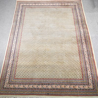 Lot 432 - A large woollen carpet, with an all over...