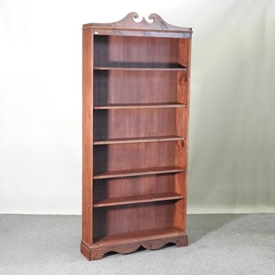 Lot 122 - A pine standing open bookcase, with a swan...