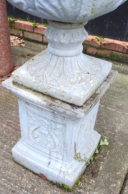 Lot 5 - A cast stone garden urn, on a plinth base,...