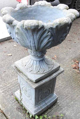 Lot 5 - A cast stone garden urn, on a plinth base,...
