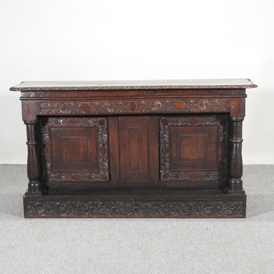 Lot 211 - An 18th century and later carved oak sideboard,...