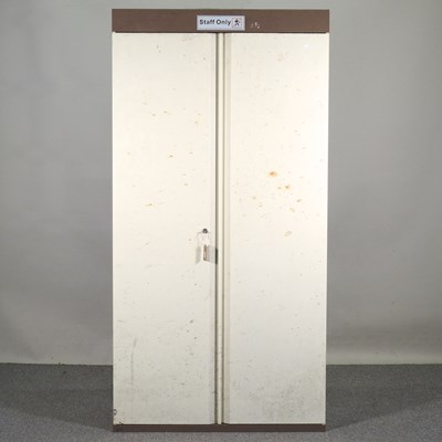 Lot 693 - A metal two door cabinet, fitted with shelves