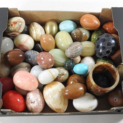 Lot 363 - A collection of polished hardstone eggs,...