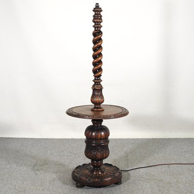 Lot 282 - An early 20th century carved oak standard lamp,...