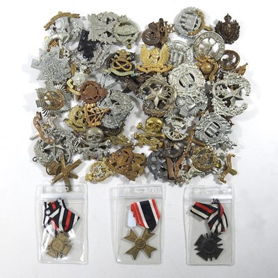 Lot 243 - A large collection of military cap badges,...