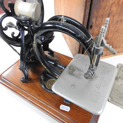 Lot 22 - A 19th century Willcox & Gibbs sewing machine,...