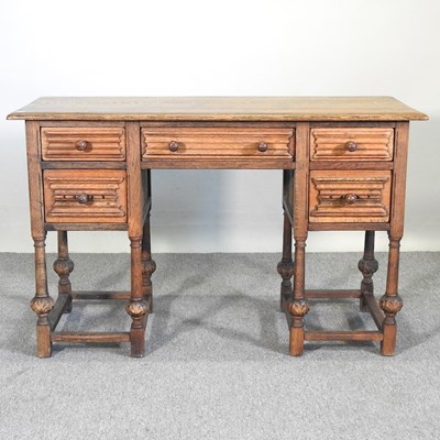 Lot 650 - A mid 20th century oak desk, containing five...