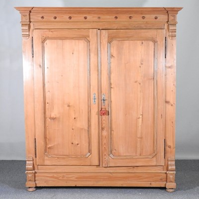 Lot 140 - An antique pine French armoire, enclosed pair...