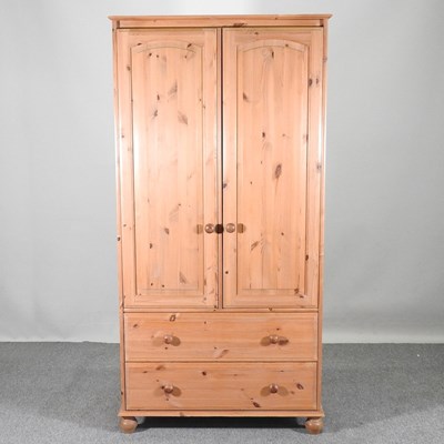 Lot 560 - A modern pine double wardrobe, together with a...